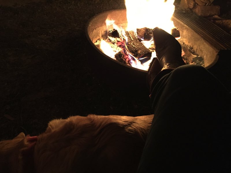 Resting my weary legs on a dog and a campfire